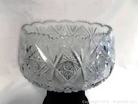 Side view of the punchbowl showing cut glass star and diamond patterns and sawtooth scalloped rim.