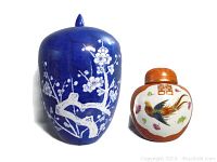 Photo of both jars side by side showing size difference and decorative motifs.