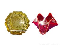 Two vintage glass ashtrays shown together: yellow starburst patterned ashtray and red Viking ruby ashtray.