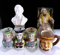 White ceramic bust, elderly man figurine in green chair, three small character figurines, and a character mug in single image showing scale and details.