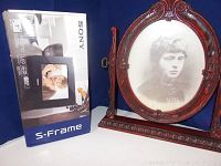 Photo showing Sony S-Frame digital photo frame in original box next to vintage oval cherry-wood frame with portrait photo