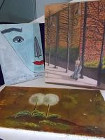 Three paintings by Pat Moretti with two paintings upright and one laying flat. Left painting is abstract face titled 'Eyes to See'. Right painting showing couple hugging by trees titled 'Close to You'. Bottom painting showing two dandelions titled 'Dandelions'.
