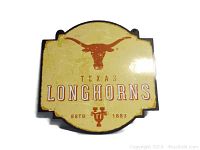 Front view of the vintage Texas Longhorns wall sign showing the logo, text, and distressed finish.