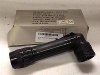 Black GI style angled flashlight with fluorescent lenses showing details on box about battery size (C cell), lumens (55), and origin (Made in China).