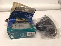 Photo of dog training collar accessories including PetSafe indoor bark control device in original packaging and a sealed Dogtra remote transmitter.