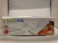Photo of V Slicer Plus Mandoline in its original box with branding and product images.
