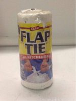 Roll of Glad Flap Tie tall kitchen bags with 40 bags included, packaging is white and yellow with blue hands tying bag flap.