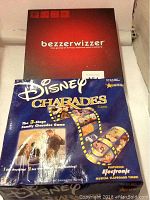 Photo showing Bezzerwizzer trivia and Disney Charades board games in their original boxes.
