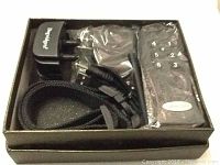 Top view of Dogwidgets dog training collar set including remote control, collar receiver, strap, and charger inside a box.