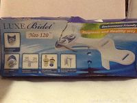 Photo of the boxed Luxe Bidet Neo 120 with product images and text highlighting features such as environment friendliness and hygiene.