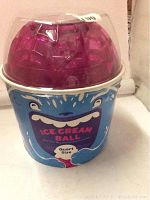 Front view of the quart size ice cream ball maker showing the blue container with cartoon face and clear purple lid.