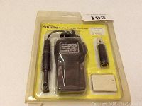 Radio Trigger Receiver Model RT-017 in original packaged yellow blister pack with accessories visible.