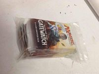 Six Magic The Gathering Oath of the Gatewatch booster packs in a sealed plastic bag.