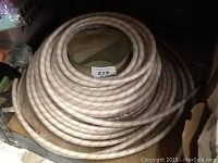 Image of a coiled white air hose measuring approximately 50 feet.