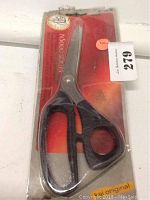 Photo shows a single pair of N5000 Series dressmakers scissors in original sealed packaging with red and orange background.