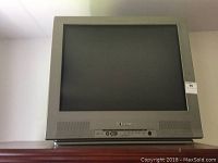 Front view of Emerson 33-inch CRT TV showing blank screen and control panel.