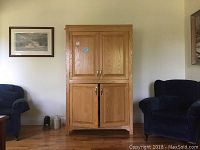 View of the full wooden cabinet closed, showing the four-panel door design.