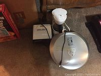 Three small kitchen appliances: Mr Coffee coffee pot in white with glass carafe, small George Foreman grill, and larger George Foreman grill with attached spatula.