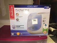 Front view of the Sunbeam Cool Mist Purified Mist Humidifier box showing product features: 24-hour mist, shatterproof tank, fresh cool moisture, suitable for small rooms.