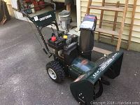 Side angled view of Craftsman snow blower showing overall condition, engine controls, and tires.
