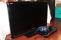 Toshiba Regza TV with HDMI cable and BluRay player next to it on floor