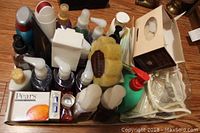 Various bottles of hand soap, lotion, bar soap box and bath sponge arranged in a container