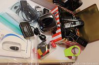 Overview of Panasonic and Vtech cordless landline phones along with cables and charger accessories on a table including a partially visible green cell phone stand.