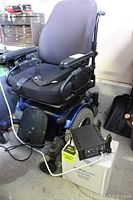 Front-angle view of wheelchair showing seat, footrest and drive module