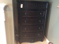 Full front view of the tall chest showing all five drawers, carved frame and ring pulls