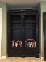 Front view of full bookcase showing overall structure, shelves, and drawers.