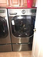 Full front view of LG dryer next to matching washer showing overall appearance and finish