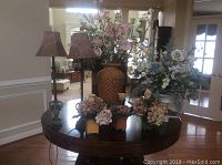 Full view of table with all lamps and floral arrangements in natural room setting