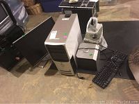 Photo showing Dell computer tower, Dell monitor, Dell keyboard, and Dell speakers on floor.