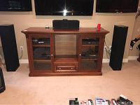 Front view of cabinet with glass doors and open shelf.
