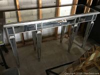 Mirrored console table front angled view showing drawer and legs
