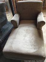 Front view of beige chaise lounge showing seat and armrests