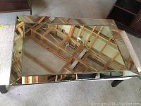 Top view of rectangular mirror placed flat, showing beveled mirrored frame.