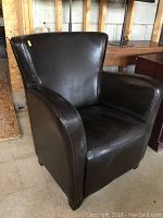 Front angle view showing the chair's dark brown leather upholstery and general shape.