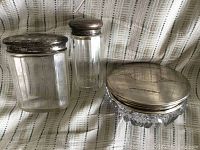Full set of three ladies dresser jars showing variety in glass shapes and sterling silver lids