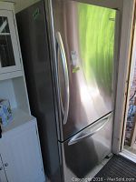 Front exterior view of stainless steel refrigerator showing body and door handles