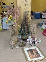 Overall lot showing two large vases with artificial reeds, various small figurines, brass leaves, and framed print on floor.