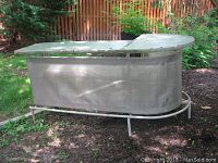 Full side view of outdoor bar showing curved metal mesh frame and glass top