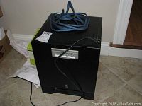 Front view of Yamaha YST-SW315 subwoofer showing control panel and power cord on top.