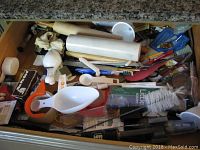 Overview of drawer contents showing rolling pin, spatulas, scoops, and various utensils.