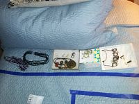 Overview of assorted costume jewelry laid out including necklaces, earrings, bracelets, and pendants.