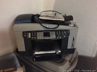 Photo of HP OfficeJet 7410 All-in-One printer showing its front and top side with control panel and paper tray.
