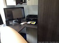 HP monitor, Logitech speakers and HP LaserJet P1102w printer on a desk showing all main items together