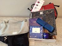 Overview of lot showing Daniel pale blue purse, three attachments, notebook, jewelry holder, and candle