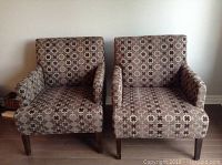 Front view of both armchairs side by side showing upholstery pattern and wooden legs