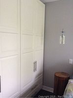 Full front view of assembled white wardrobe showing doors and drawers